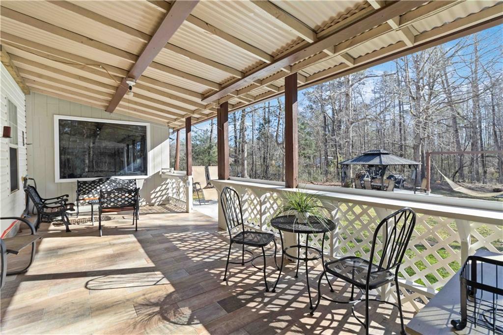 180 Harper Road McDonough, GA 30252 - Photo 40 of 63 a roof deck with table and chairs and wooden floor