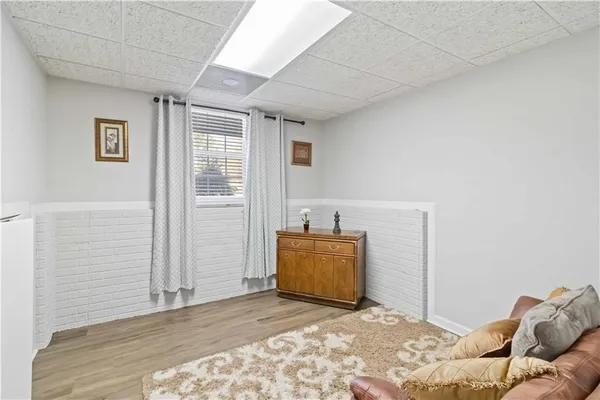 a white house that has a tree on the side of it