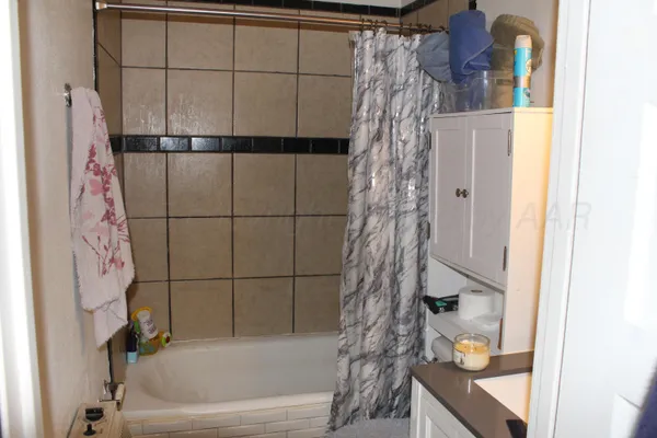 a bathroom with a bathtub and shower