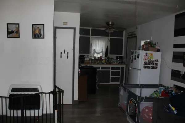 a kitchen with stainless steel appliances a refrigerator and a stove top oven
