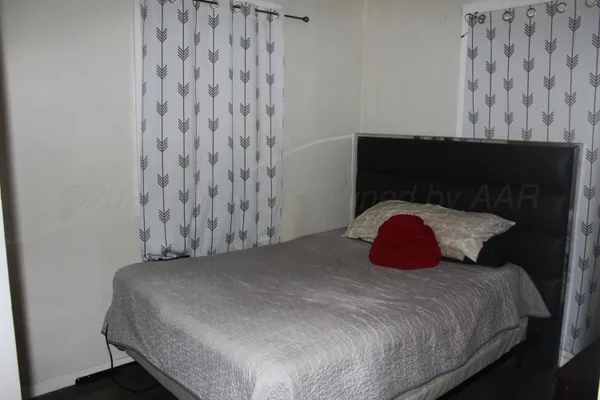 a bedroom with a bed and a wall painting