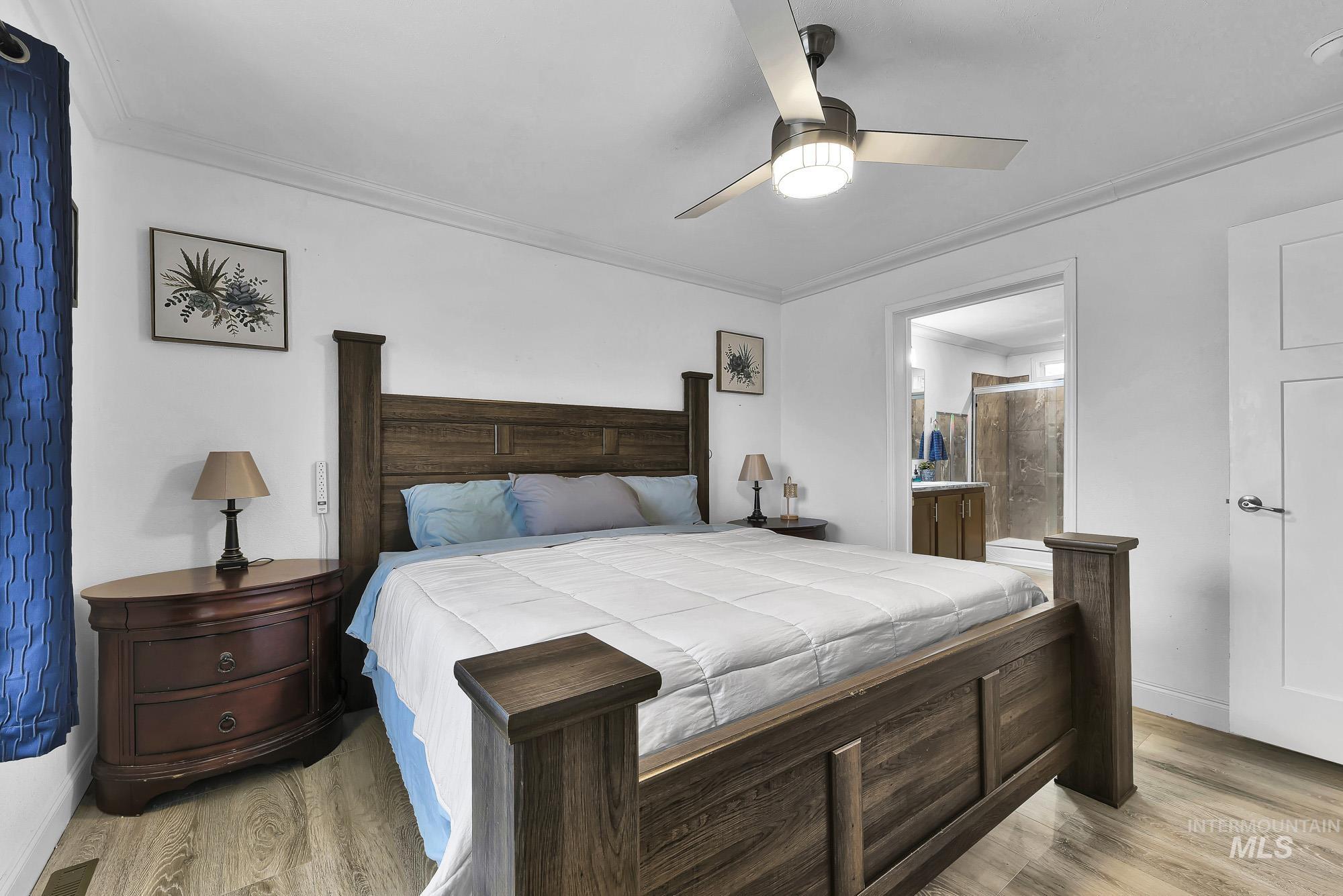 8483 West Irving Lane Boise, ID 83704 - Photo 12 of 40 Bedroom with ornamental molding, ceiling fan, light wood finished floors, and ensuite bath