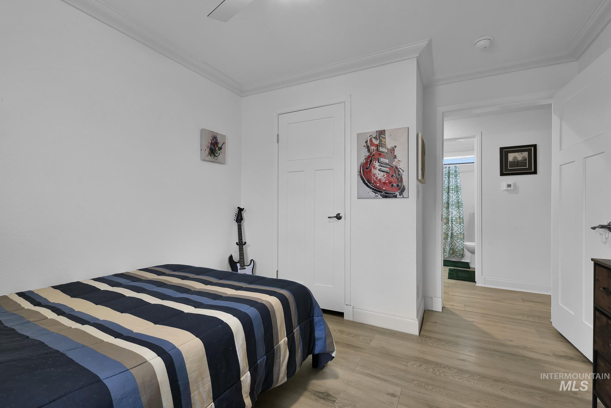 8483 West Irving Lane Boise, ID 83704 - Photo 19 of 40 Bedroom with light wood-type flooring, crown molding, and ceiling fan