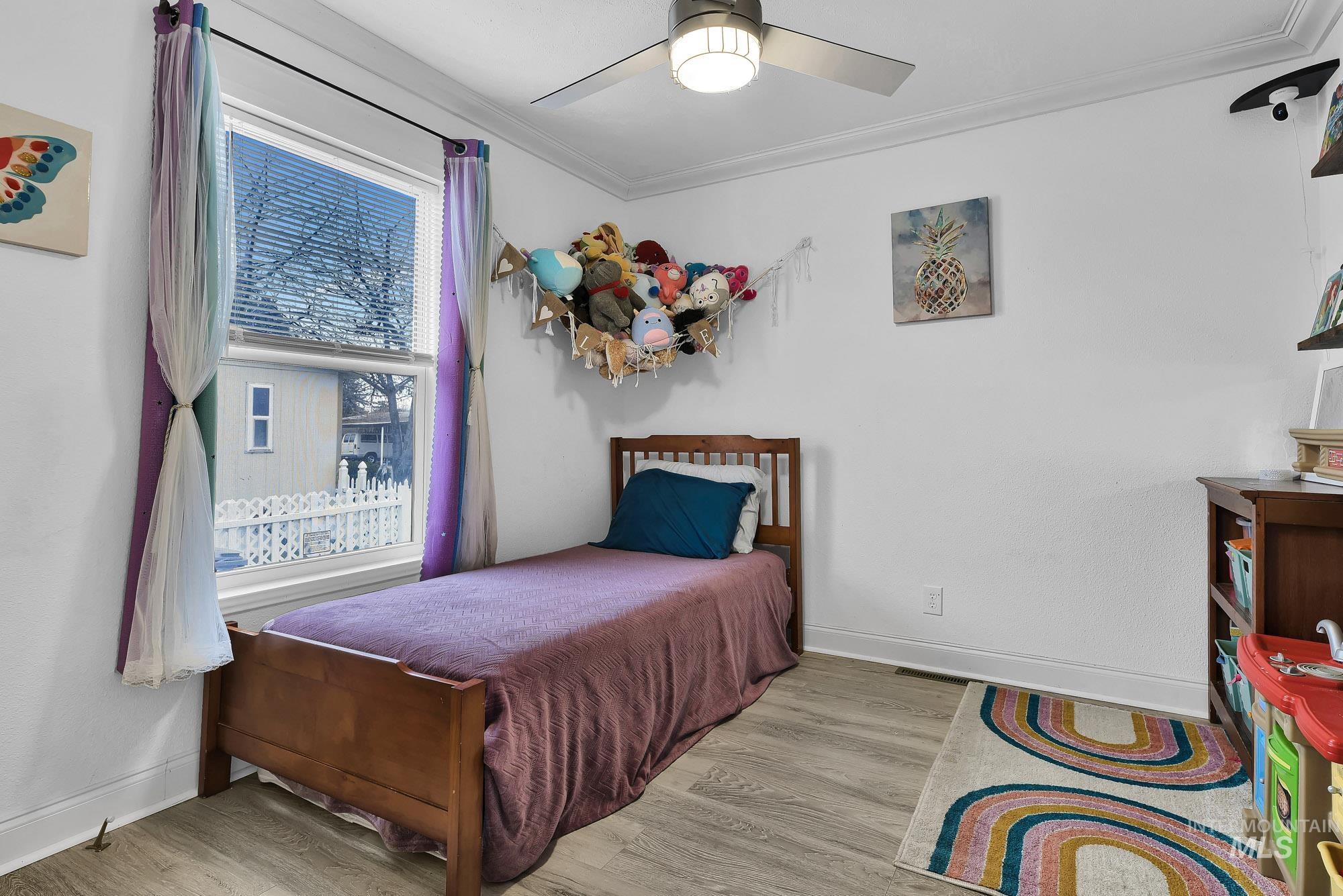 8483 West Irving Lane Boise, ID 83704 - Photo 20 of 40 Bedroom with crown molding, wood finished floors, and ceiling fan