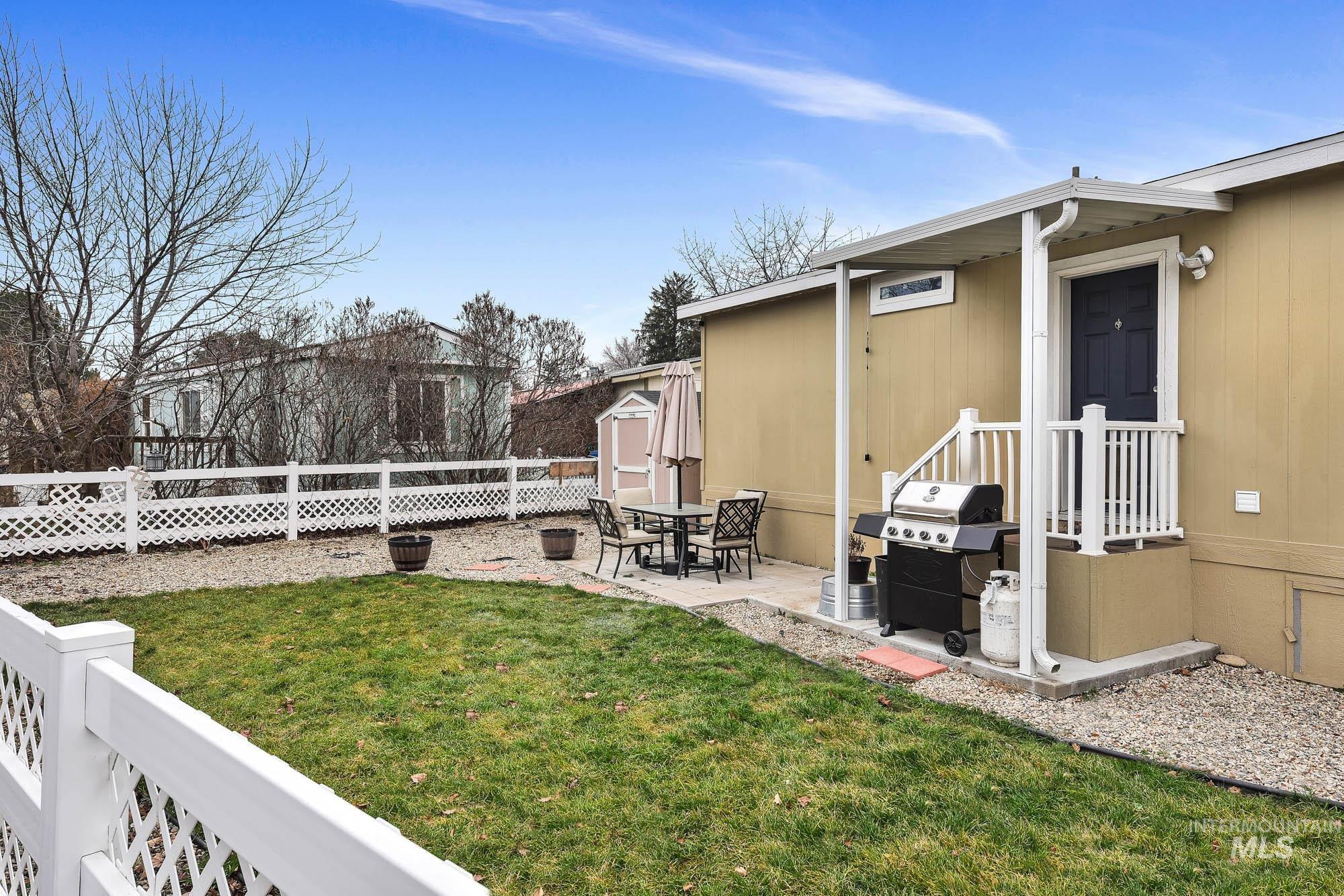 8483 West Irving Lane Boise, ID 83704 - Photo 31 of 40 Fenced yard featuring a shed, a patio area, and outdoor dining area