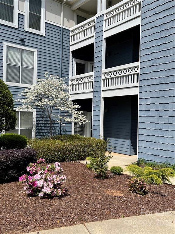 18679 Vineyard Point Lane Cornelius, NC 28031 - Photo 6 of 7 a view of a house with a yard and a garage