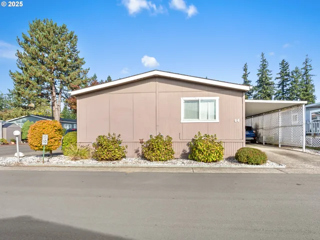 a front view of a house with a garden and outdoor seating