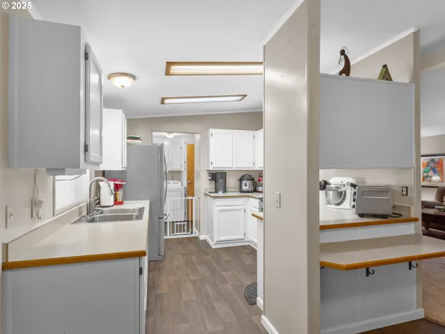 a kitchen with a sink dishwasher stove and refrigerator