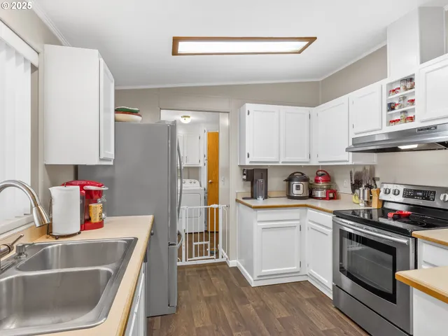 a kitchen with a sink stove and refrigerator