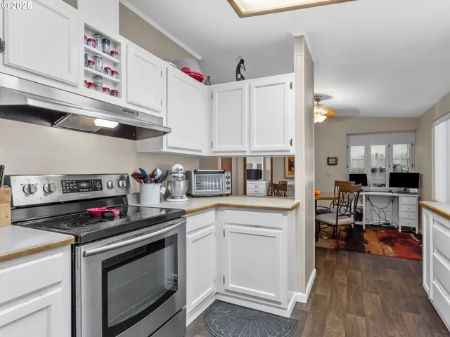 a kitchen with stainless steel appliances a stove a sink and cabinets
