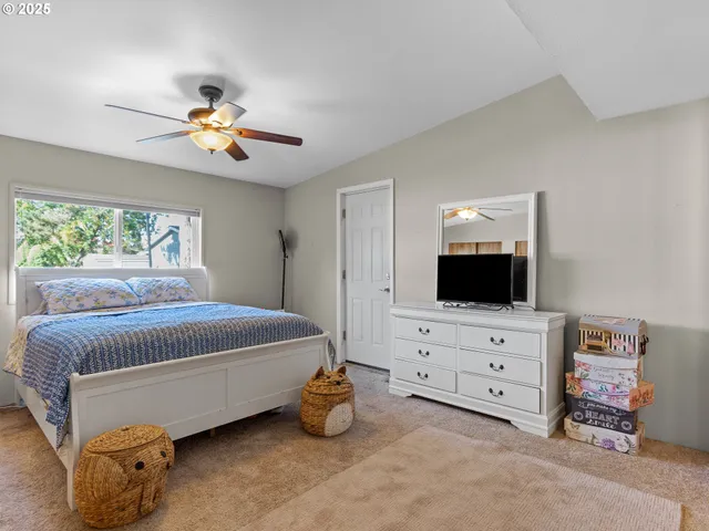 a bedroom with furniture and flat screen tv
