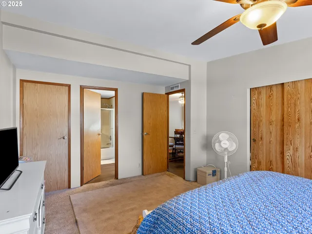 a bedroom with a bed and a table