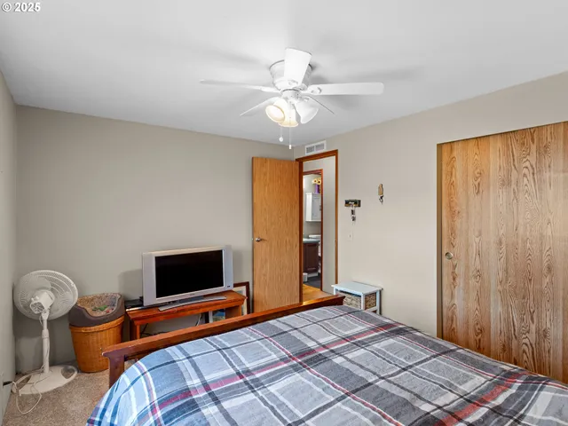 a bedroom with a bed and a television