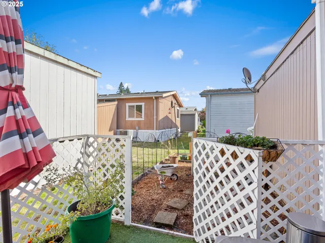 a view of a house with wooden fence