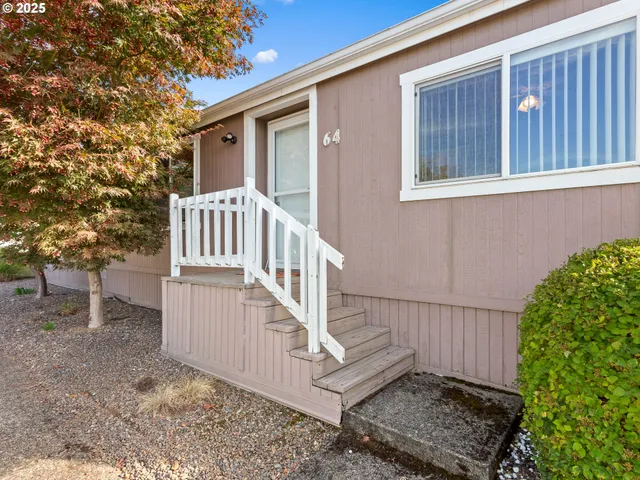 a view of a house with wooden fence and porch