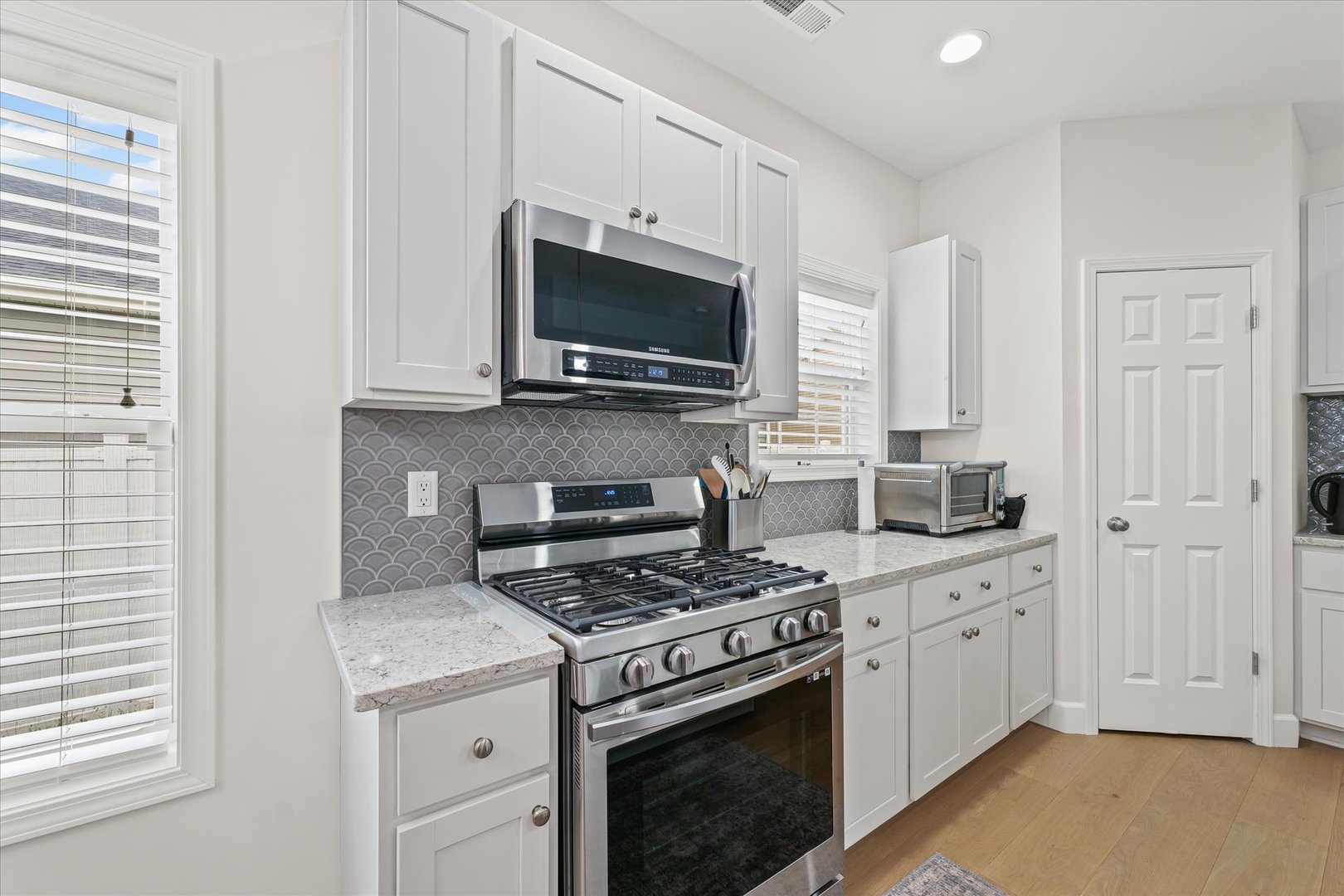 3407 Memory Lane Urbana, IL 61802 - Photo 12 of 30 a kitchen with granite countertop a stove a sink and a microwave