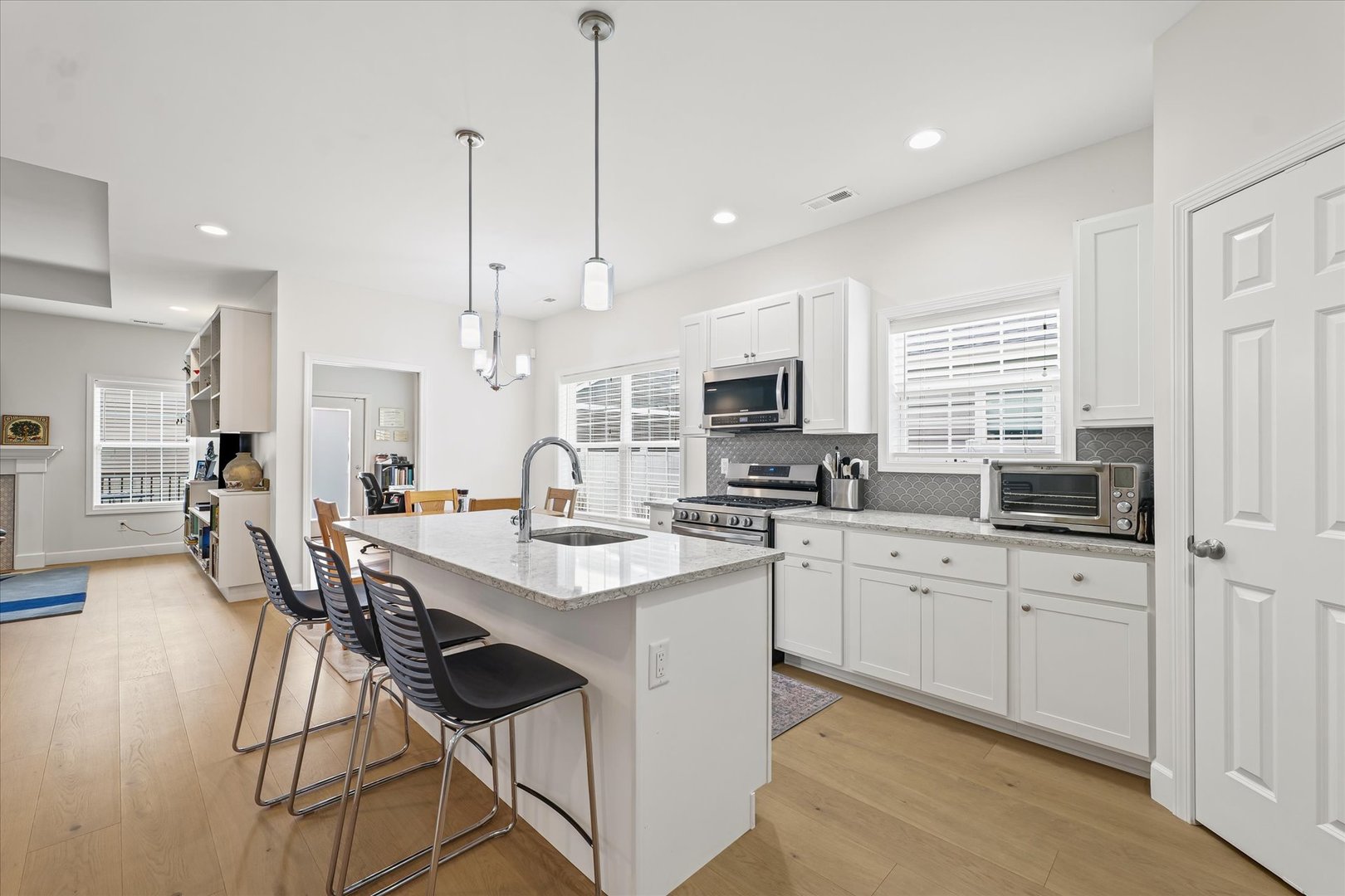 3407 Memory Lane Urbana, IL 61802 - Photo 14 of 30 a kitchen with stainless steel appliances kitchen island granite countertop a sink a stove a dining table and chairs