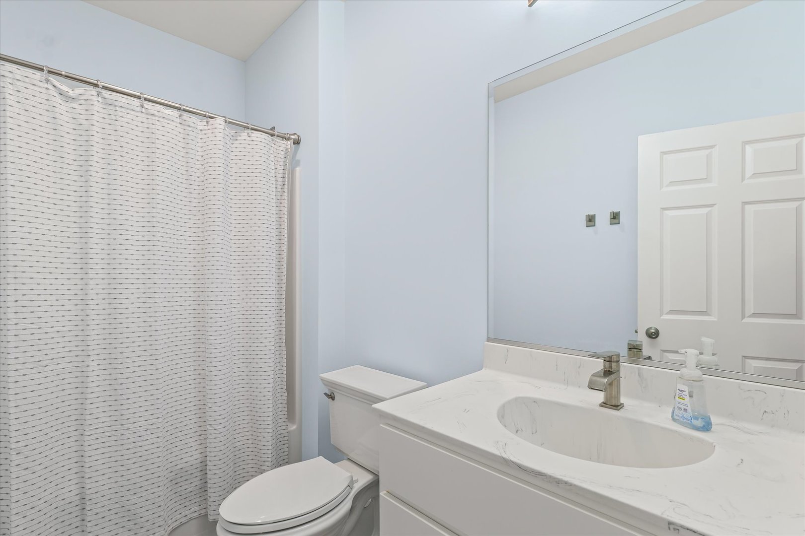 3407 Memory Lane Urbana, IL 61802 - Photo 21 of 30 a bathroom with a sink a toilet and shower curtain