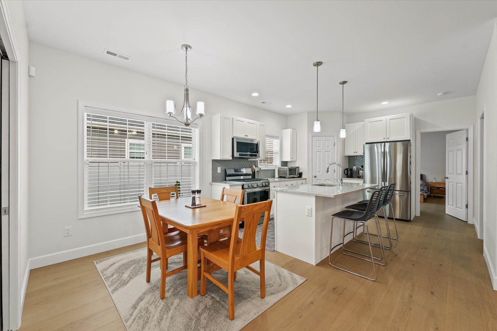 3407 Memory Lane Urbana, IL 61802 - Photo 10 of 30 a dining room with stainless steel appliances granite countertop a dining table chairs and a refrigerator