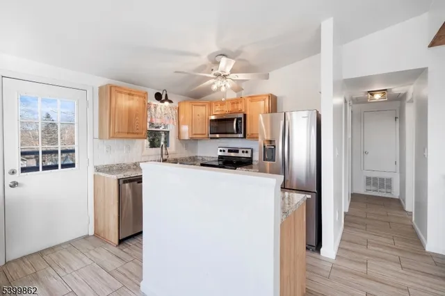 a kitchen with stainless steel appliances a refrigerator stove microwave and cabinets