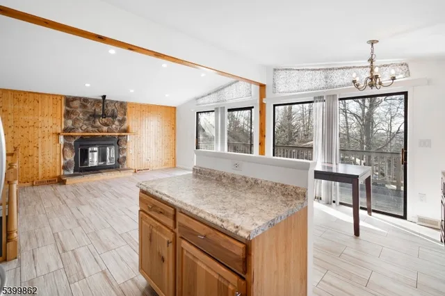 a kitchen with a wooden floor and a fireplace