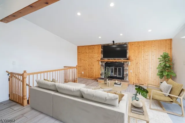 a living room with furniture a fireplace and a flat screen tv