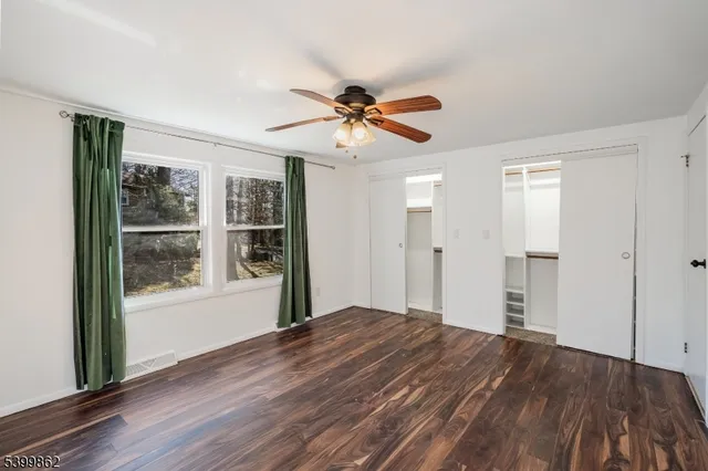 a view of a livingroom with a ceiling fan and window
