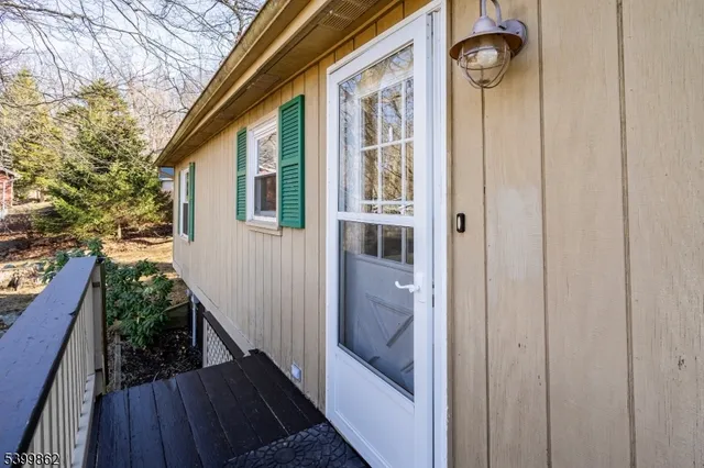 a view of a house with backyard and wooden floor