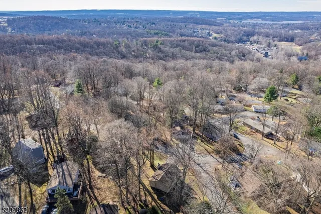 a view of a house with large trees