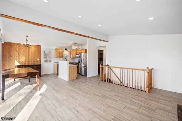 a view of a kitchen with furniture and wooden floor