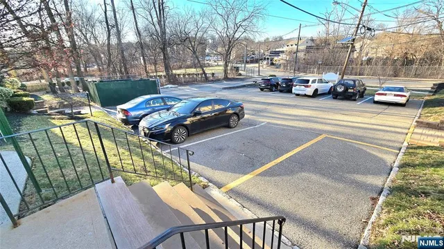 a view of a cars park on the side of a street