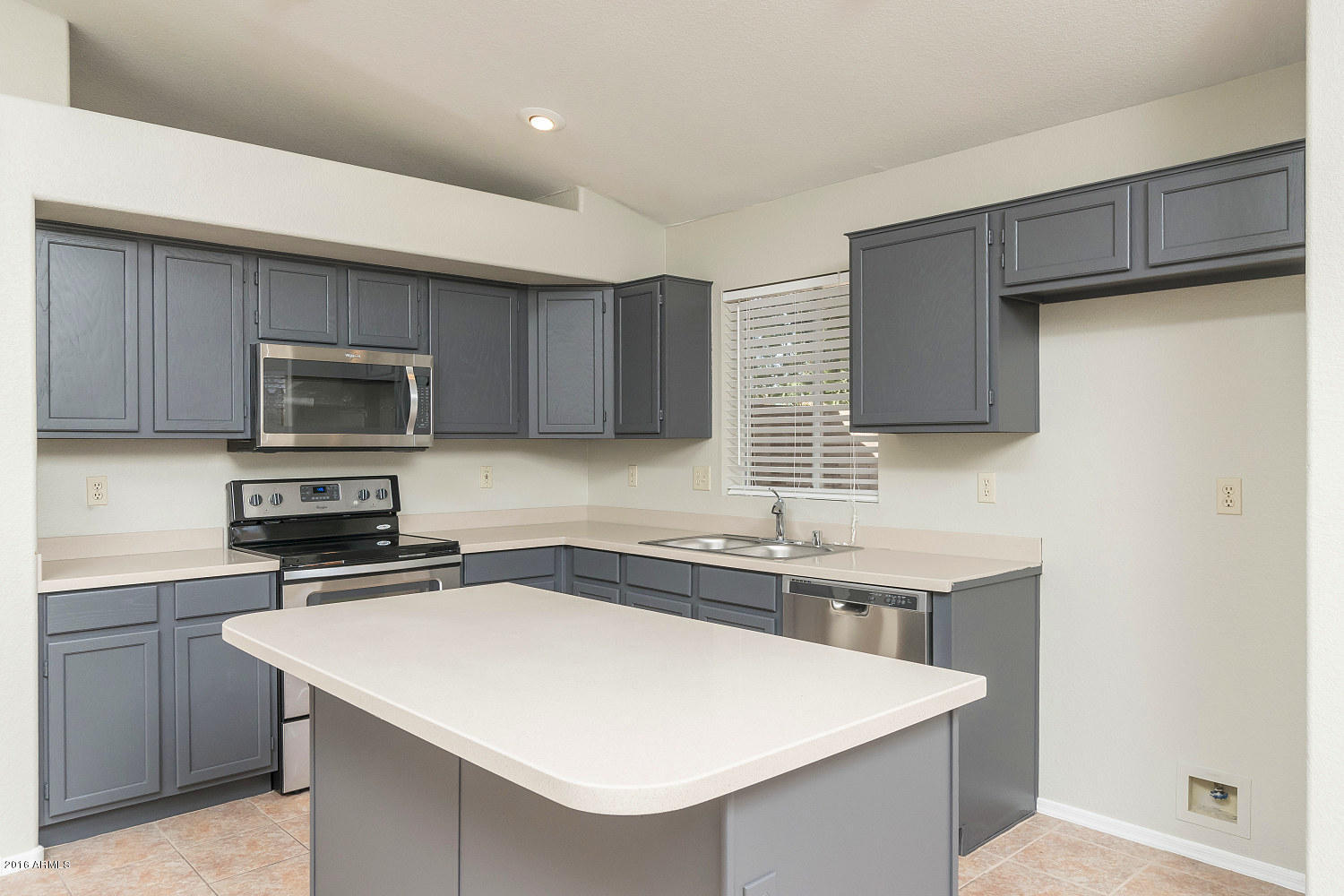 425 West Smoke Tree Road Gilbert, AZ 85233 - Photo 3 of 18 a kitchen with stainless steel appliances a sink a stove a microwave a sink a refrigerator and cabinets