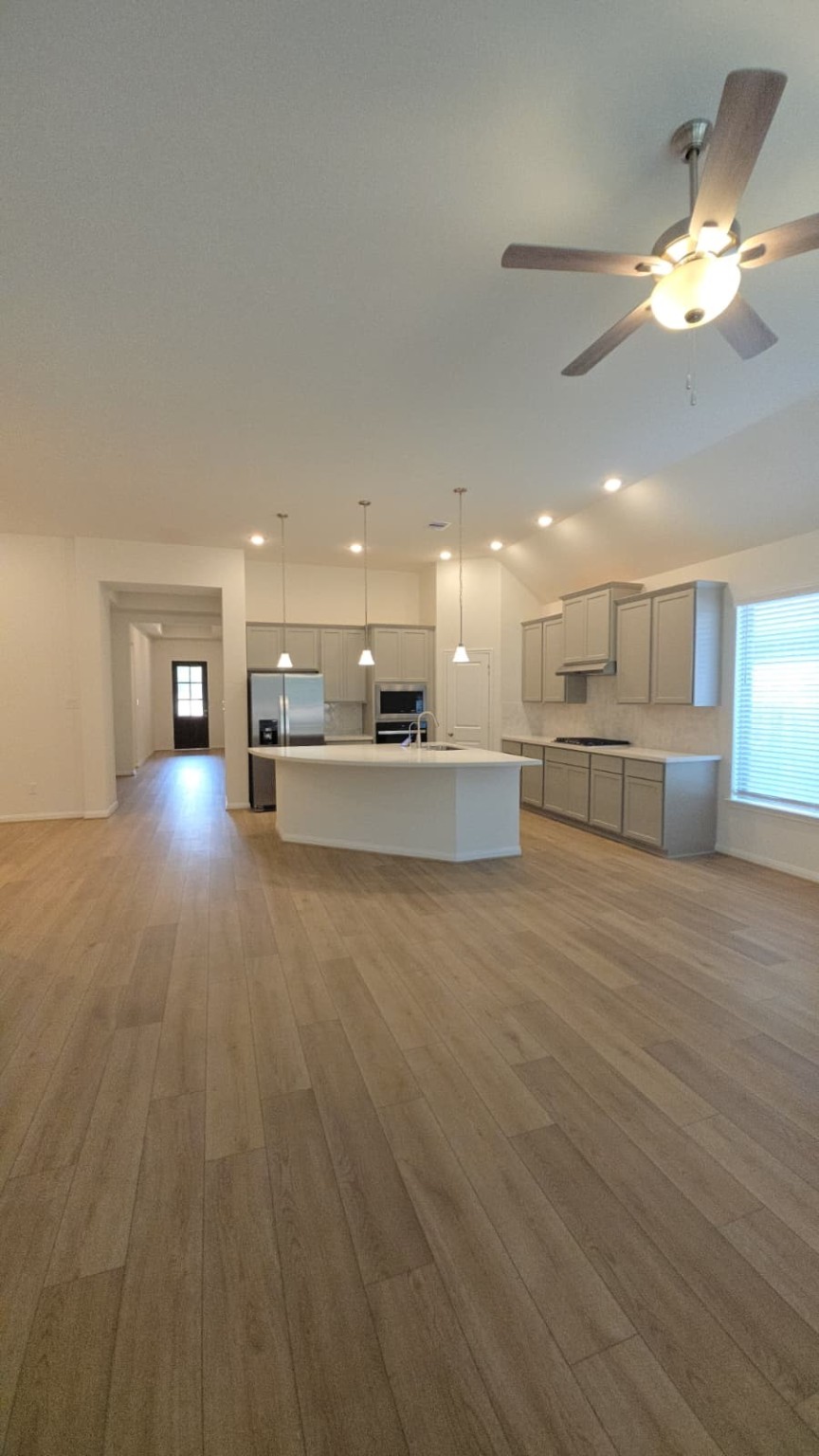 1420 Florecer Lane Magnolia, TX 77354 - Photo 4 of 36 a view of a kitchen with a sink and a stove top oven
