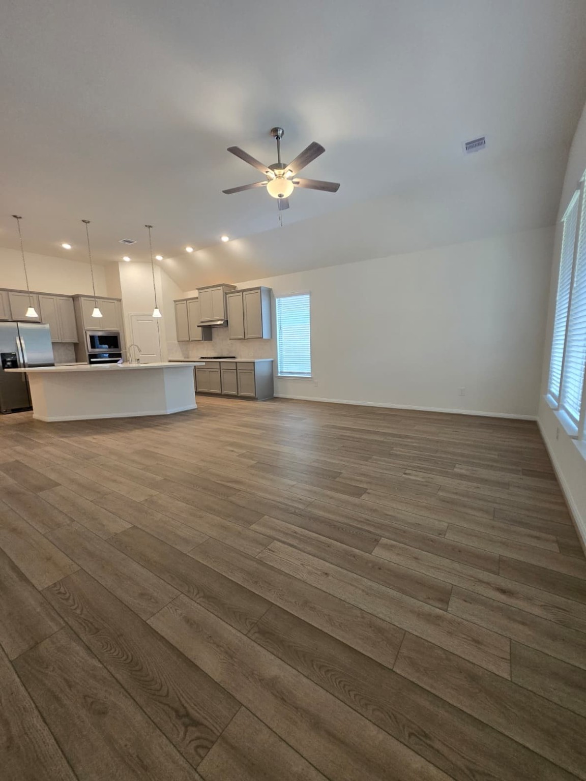 1420 Florecer Lane Magnolia, TX 77354 - Photo 5 of 36 a view of an empty room with kitchen appliances and a ceiling fan