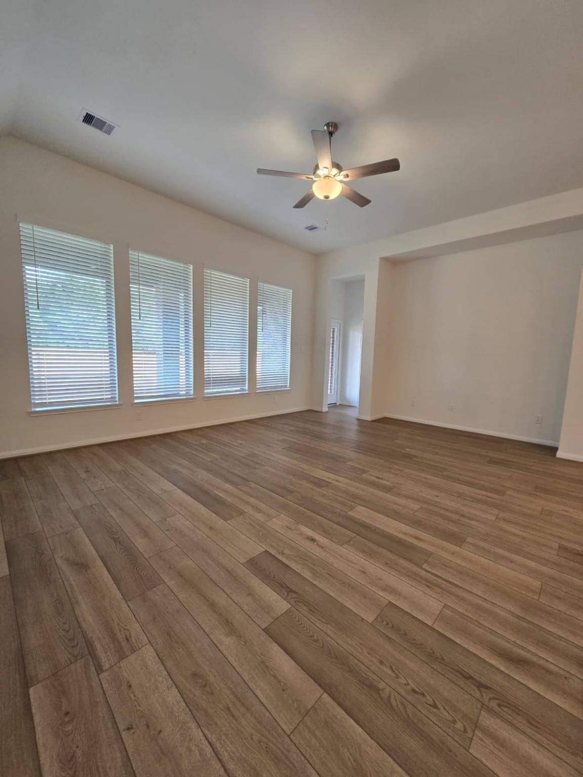 1420 Florecer Lane Magnolia, TX 77354 - Photo 6 of 36 wooden floor in an empty room with a window