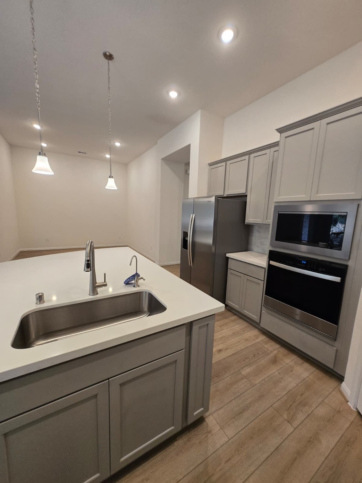 1420 Florecer Lane Magnolia, TX 77354 - Photo 8 of 36 a kitchen with stainless steel appliances kitchen island granite countertop a sink and a refrigerator