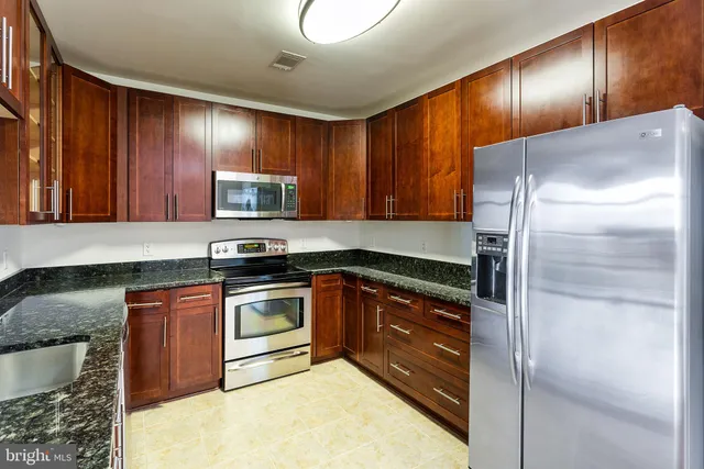 a kitchen with granite countertop cabinets and window