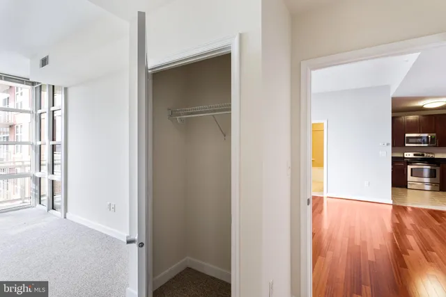 a bathroom with a granite countertop toilet sink and mirror