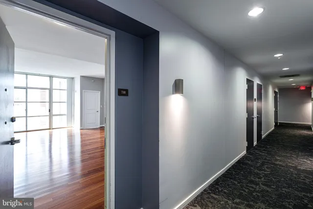 a view of hallway with wooden floor