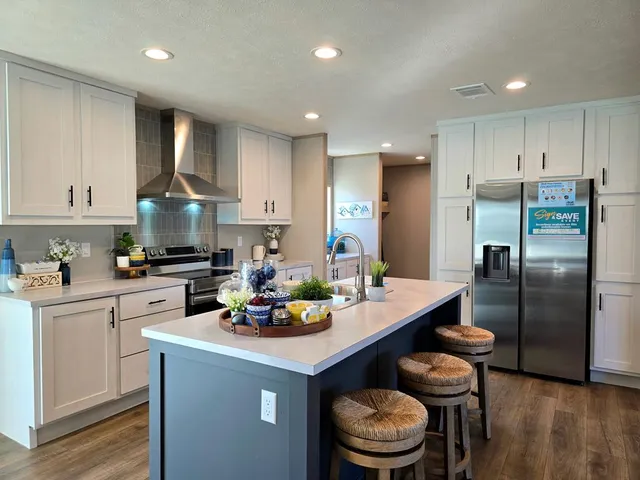 a kitchen with a refrigerator a stove a sink and a cabinets