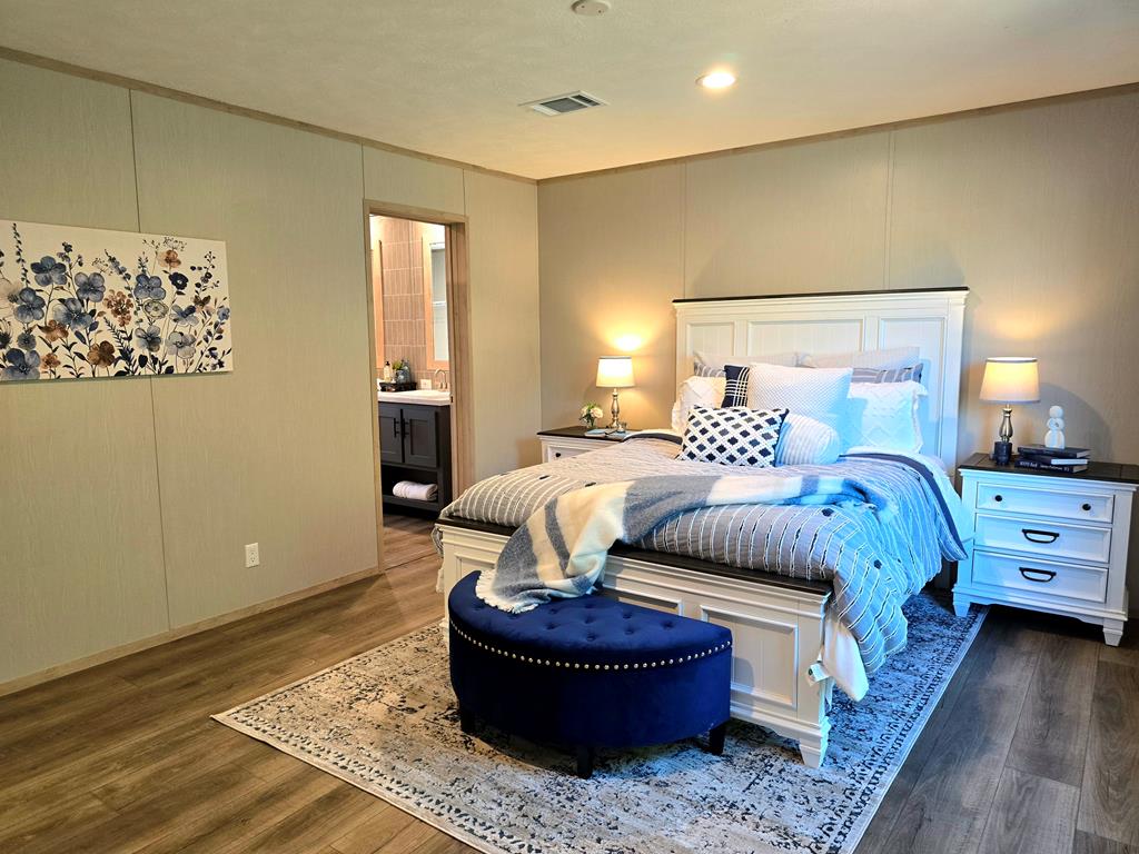 110 Deer Ridge Mason, TX 76856 - Photo 6 of 8 a bedroom with a bed and wooden floor