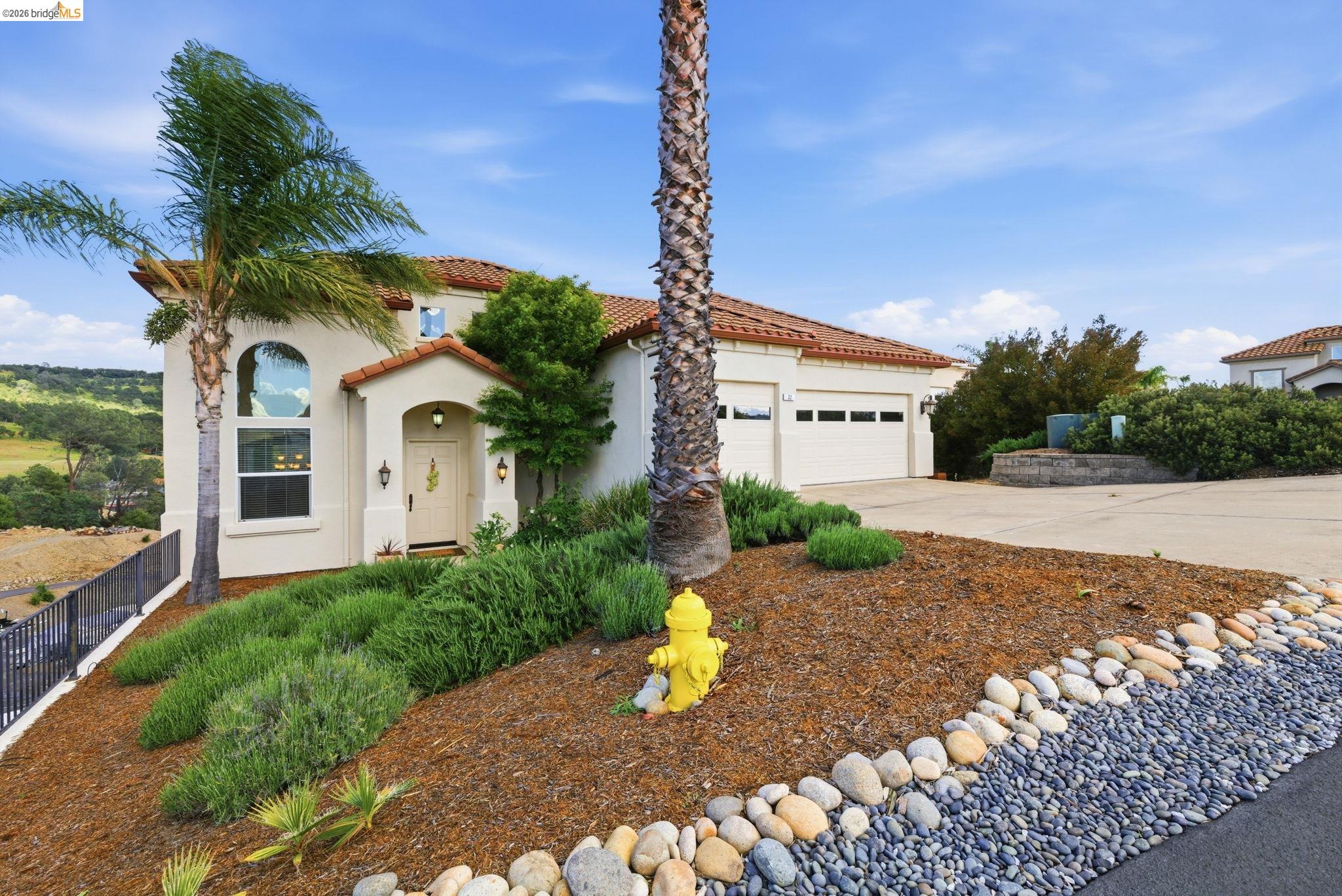 32 Apollo Lane Copperopolis, CA 95228 - Photo 47 of 58 Mediterranean / spanish-style house with stucco siding, a tiled roof, an attached garage, and concrete driveway