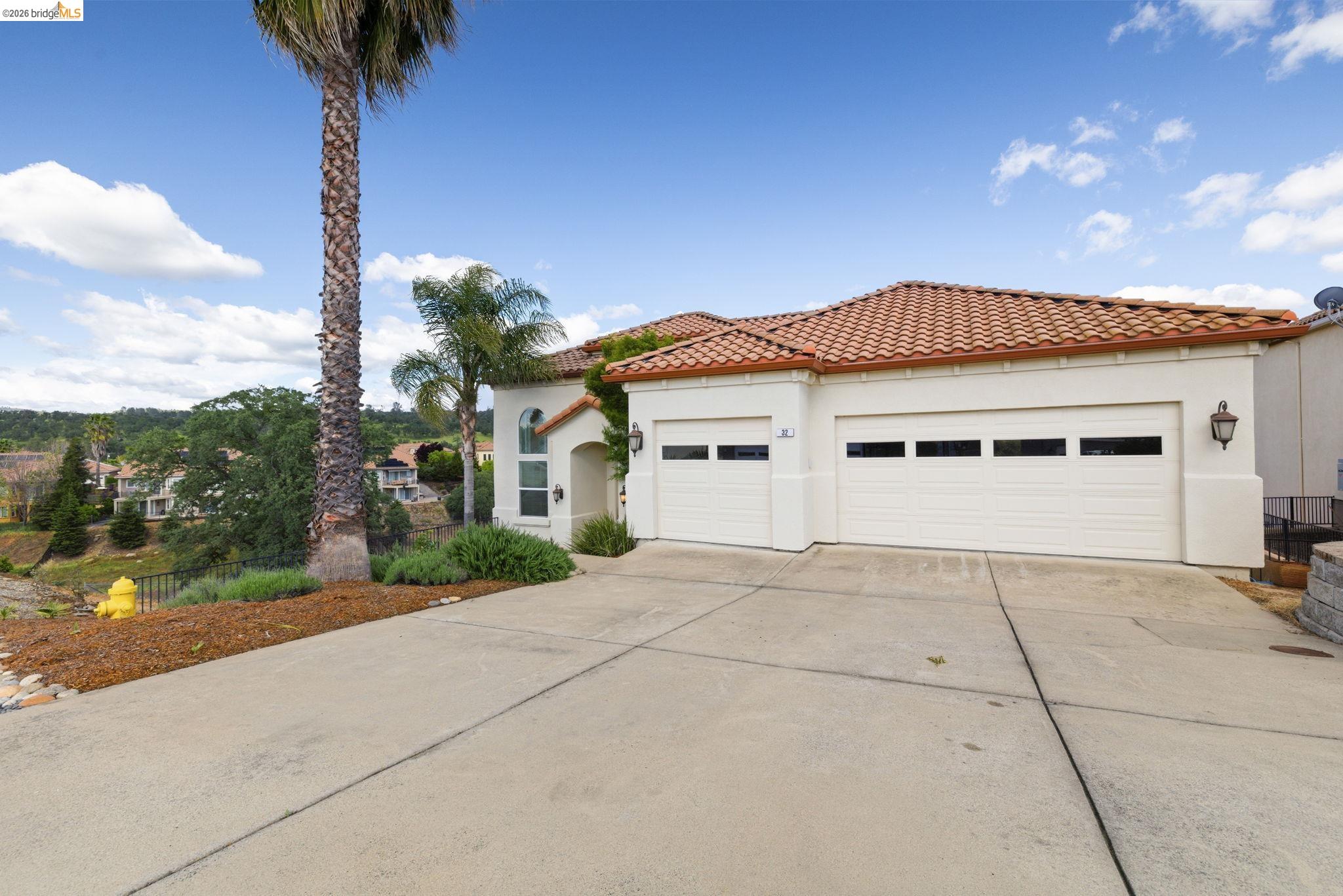 32 Apollo Lane Copperopolis, CA 95228 - Photo 48 of 58 Mediterranean / spanish home featuring concrete driveway, stucco siding, an attached garage, and a tile roof
