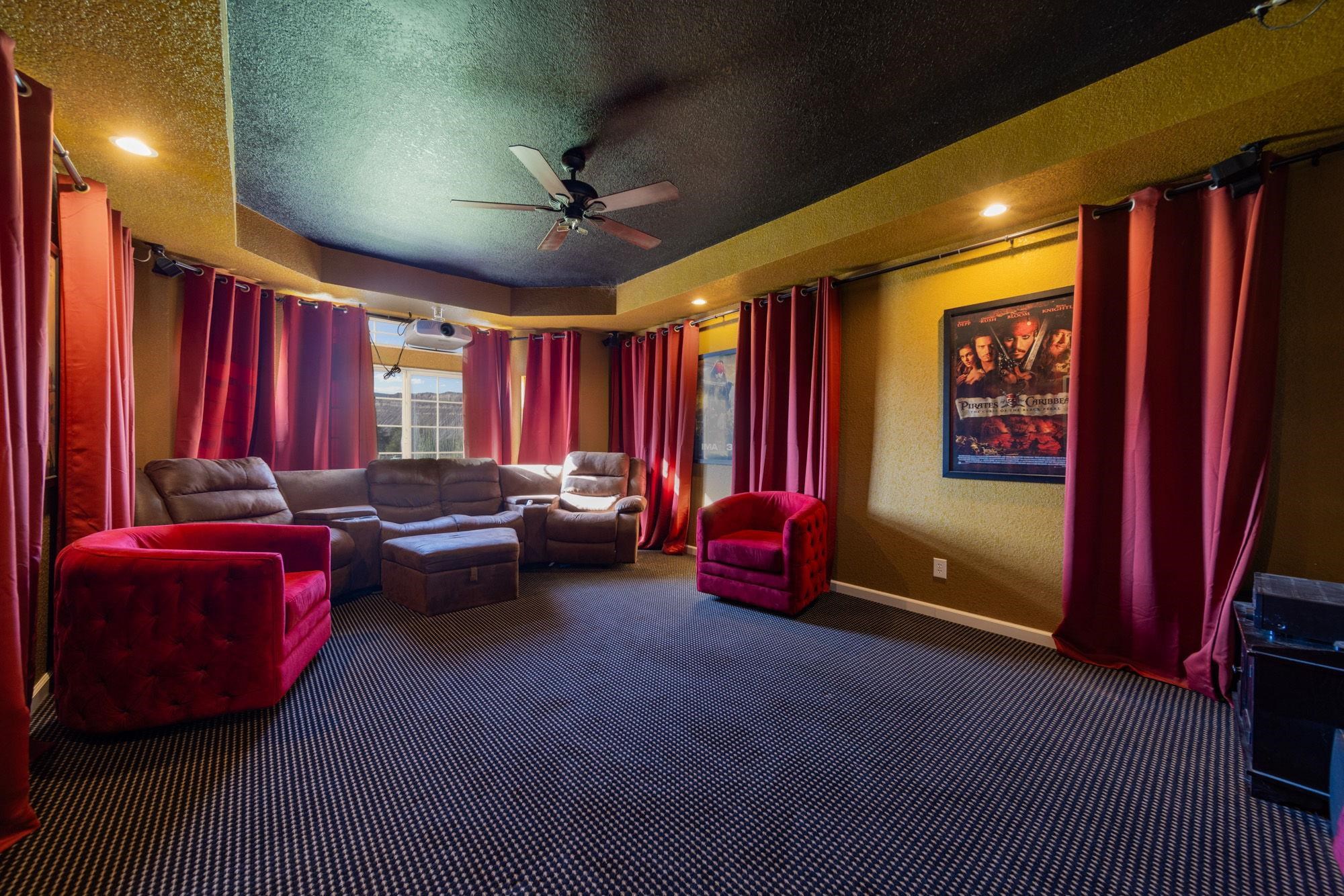 623 Sobre El Rio Drive Palisade, CO 81526 - Photo 18 of 28 a living room with furniture a projector and a flat screen tv