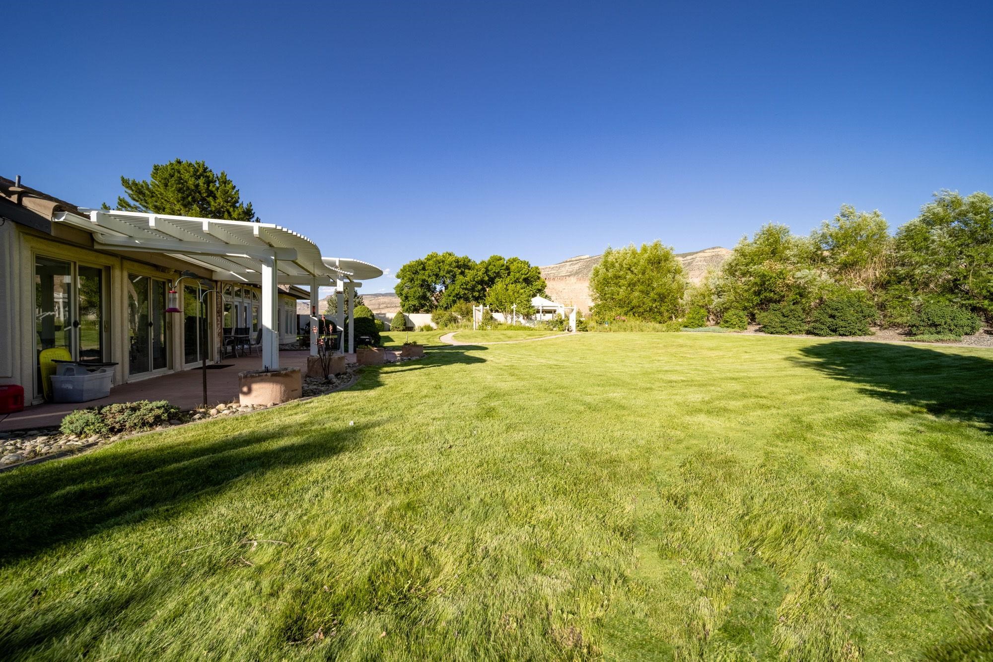 623 Sobre El Rio Drive Palisade, CO 81526 - Photo 24 of 28 a view of a house with a yard table and chairs