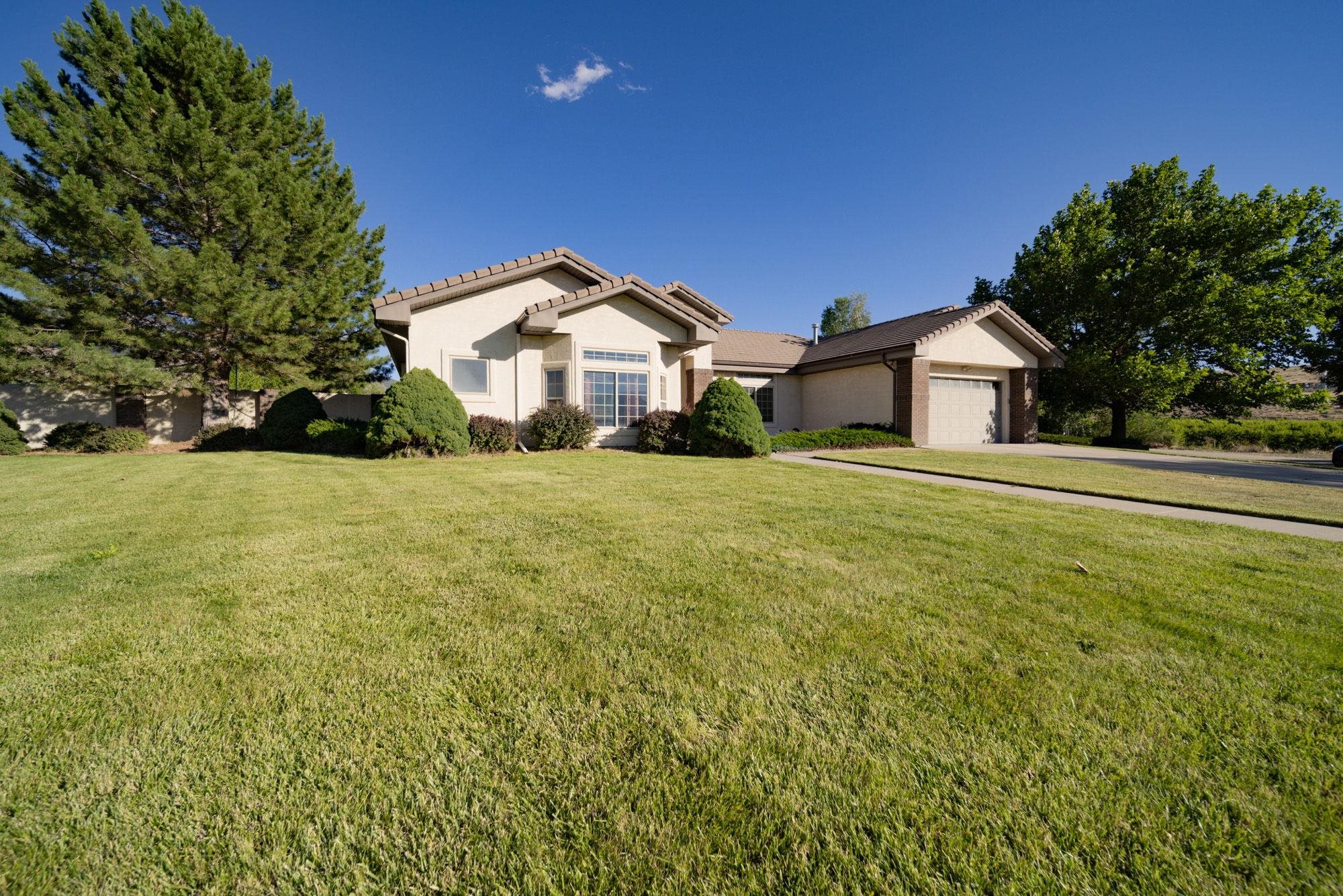 623 Sobre El Rio Drive Palisade, CO 81526 - Photo 28 of 28 a big house with a big yard and large trees