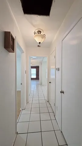 a view of a hallway with a chandelier