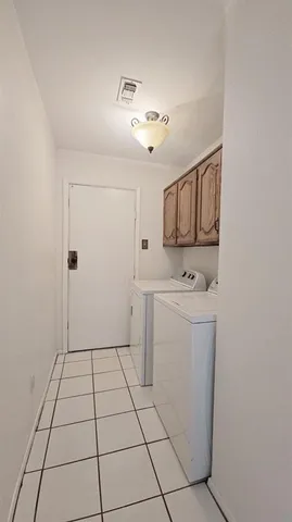 a view of a storage & utility room with cabinets