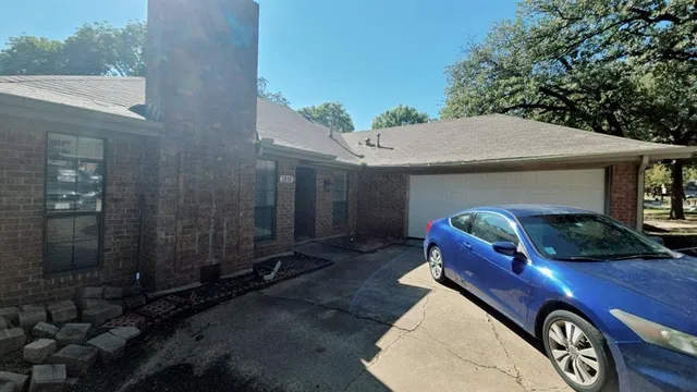 a front view of a house with parking space