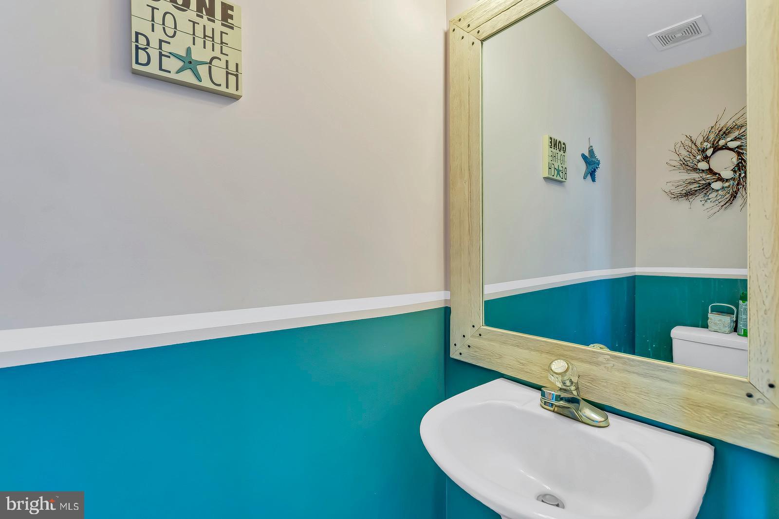 48948 Packer Court St. Inigoes, MD 20684 - Photo 18 of 45 a bathroom with a sink and a mirror